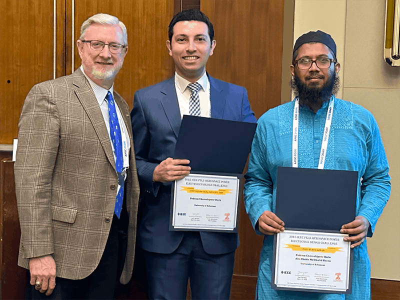 UAPG Aerospace From left to right: Alan Mantooth, Pedram Heris and Abu Shahir Md Khalid Hasan. Heris and Hasan hold the awards they received at the IEEE Aerospace Power Electronics Design Challenge.
