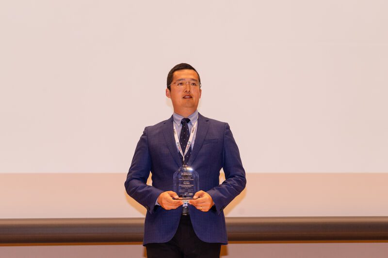 Yue Zhao holding the Isao Takahashi Power Electronics Award